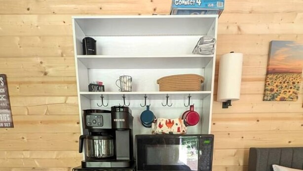 A compact kitchenette with a coffee maker, microwave, and a small refrigerator. - Luxury Woodland Cabin Near The Caverns & Savage Gulf, Tennessee (Coalmont)