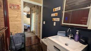 A bathroom with a white sink, a mirror, and a towel rack. - Luxury Woodland Cabin Near The Caverns & Savage Gulf, Tennessee (Coalmont)