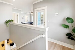 A modern interior with a staircase, a pool table, and a plant. - Stylish Coastal Home with Private Pool & Golf Cart, Steps from Beach near Miramar Beach, Florida (Miramar Beach)