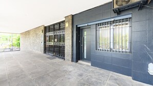 A building exterior with a gated entrance, a door, and a window with bars. - (MDV120) Study in Carabanchel, Madrid (Madrid)
