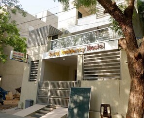 A building with a sign reading 'Sahaj Residency Hostel' and a gated entrance. - Nova Sahaj Residency (Rajkot)