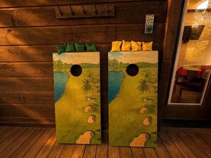 Two wooden doors with tropical landscape paintings, a wooden wall, and a sign indicating 'ON LAKE TIME'. - Cozy Cabin with Hot Tub & Fire Pit Easy Access to Nearby Lakes and Trails in Broken Bow, Oklahoma (Broken Bow)