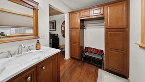 A kitchen with wooden cabinets, a marble countertop, and a built-in oven.