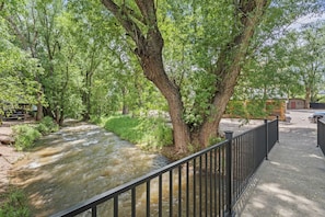 A river flowing through a park with trees and a metal fence. - Rustic A-Frame Cabins with Tranquil Nature Views near Garden of the Gods in Colorado Springs, Colorado (Colorado Springs)