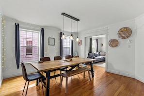 A dining area with a wooden table, chairs, and pendant lights. - BLVD QV Lake House  4BR  Backyard  Pets  Parking (St. John's)