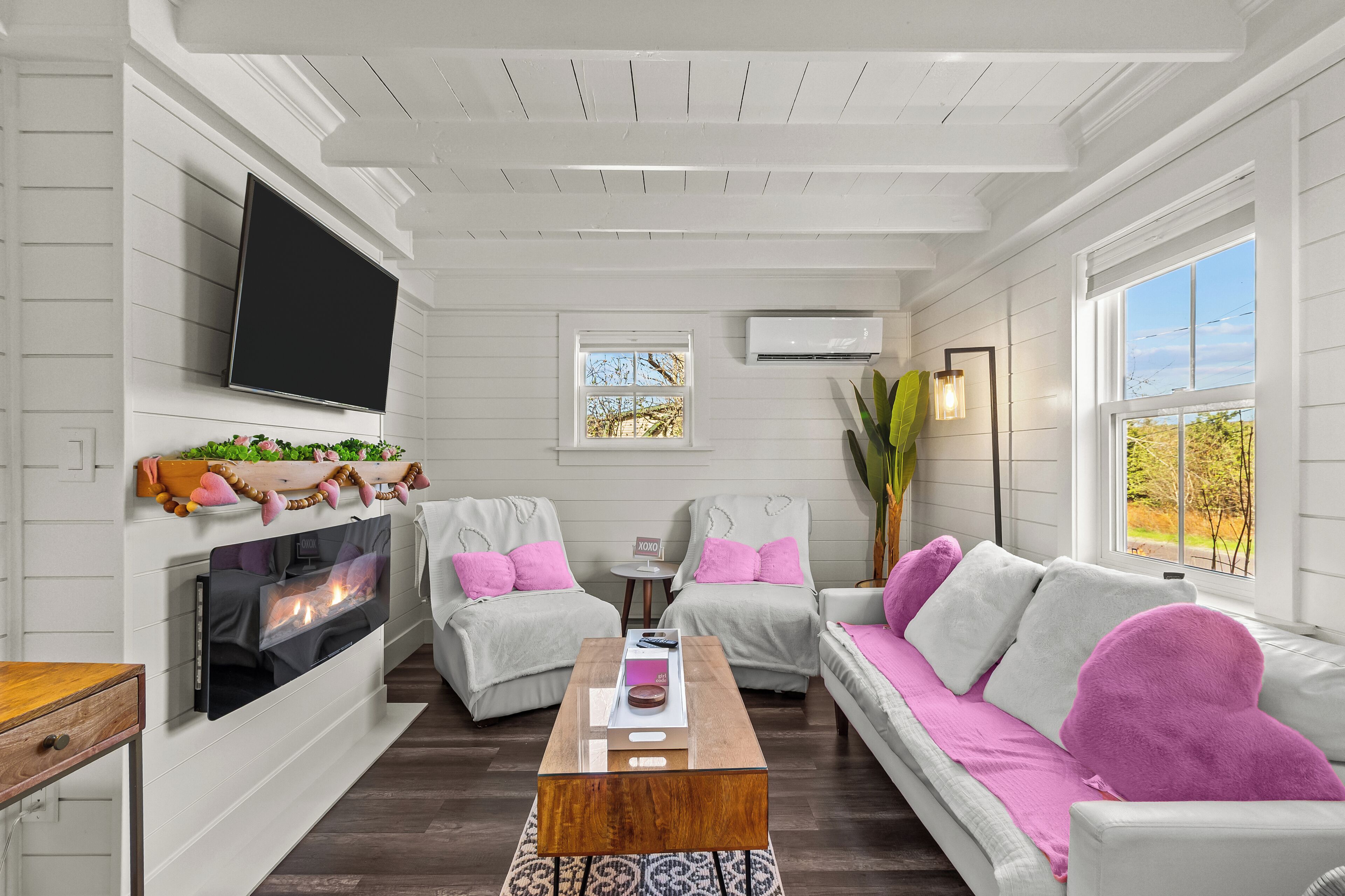 Cozy living room with bright natural light & comfy seating.