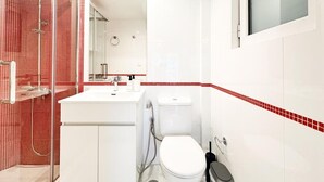 A modern bathroom with a glass shower enclosure, a white sink, and a toilet. - Bright Modern 1BR · 4-min Walk to the Sea · Alimos Riviera (Alimos)