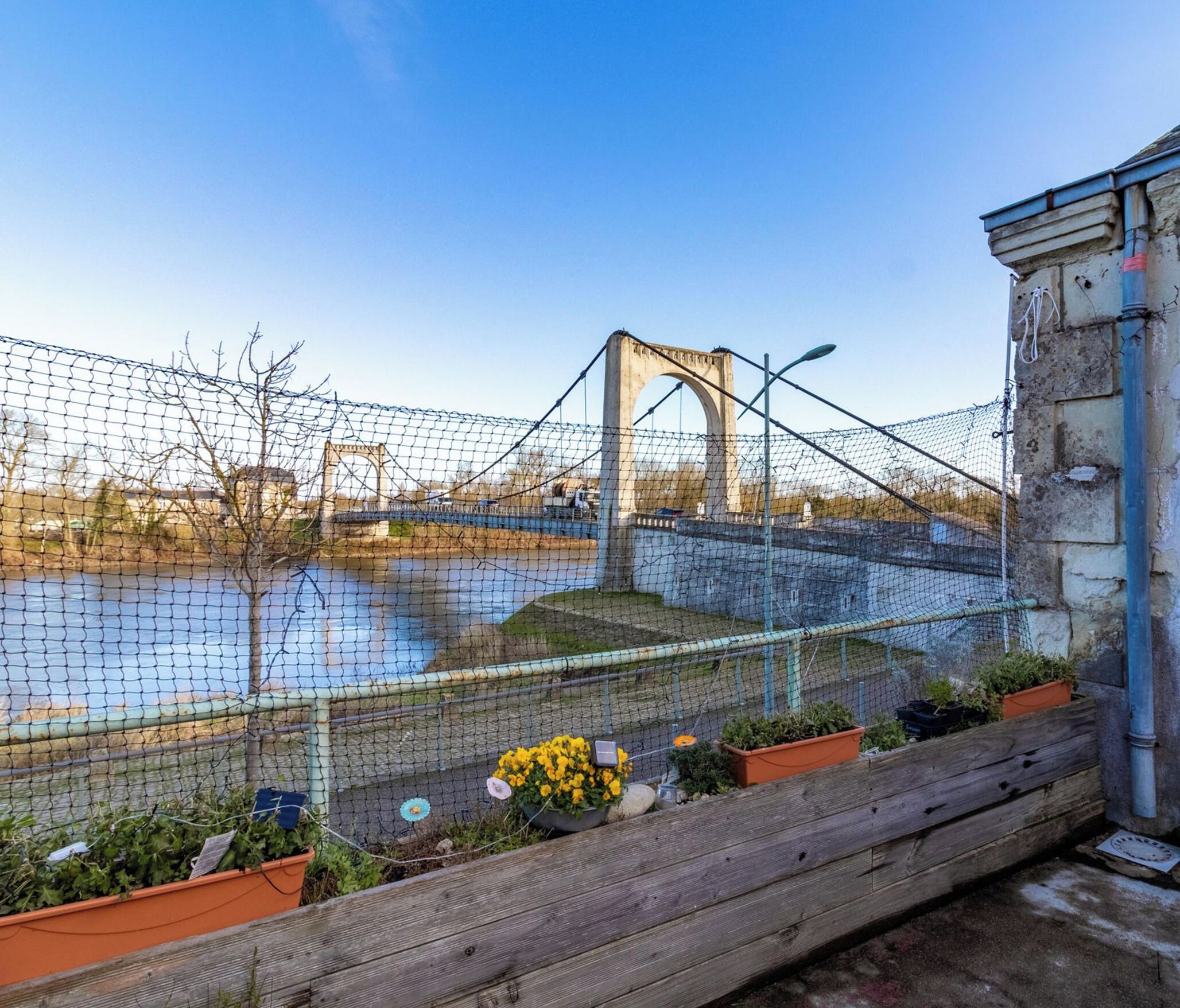 A view of a bridge with a chain-link fence in the foreground.