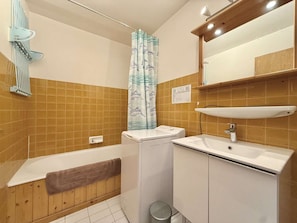 Ein Badezimmer mit einer Badewanne, einem Waschbecken und einer Duschvorhang.