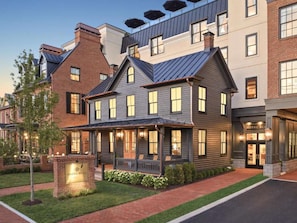 A hotel with a brick facade, large windows, and a well-lit entrance. - Historic Leesburg Stay w/ Bunkbeds + Sauna (Leesburg)