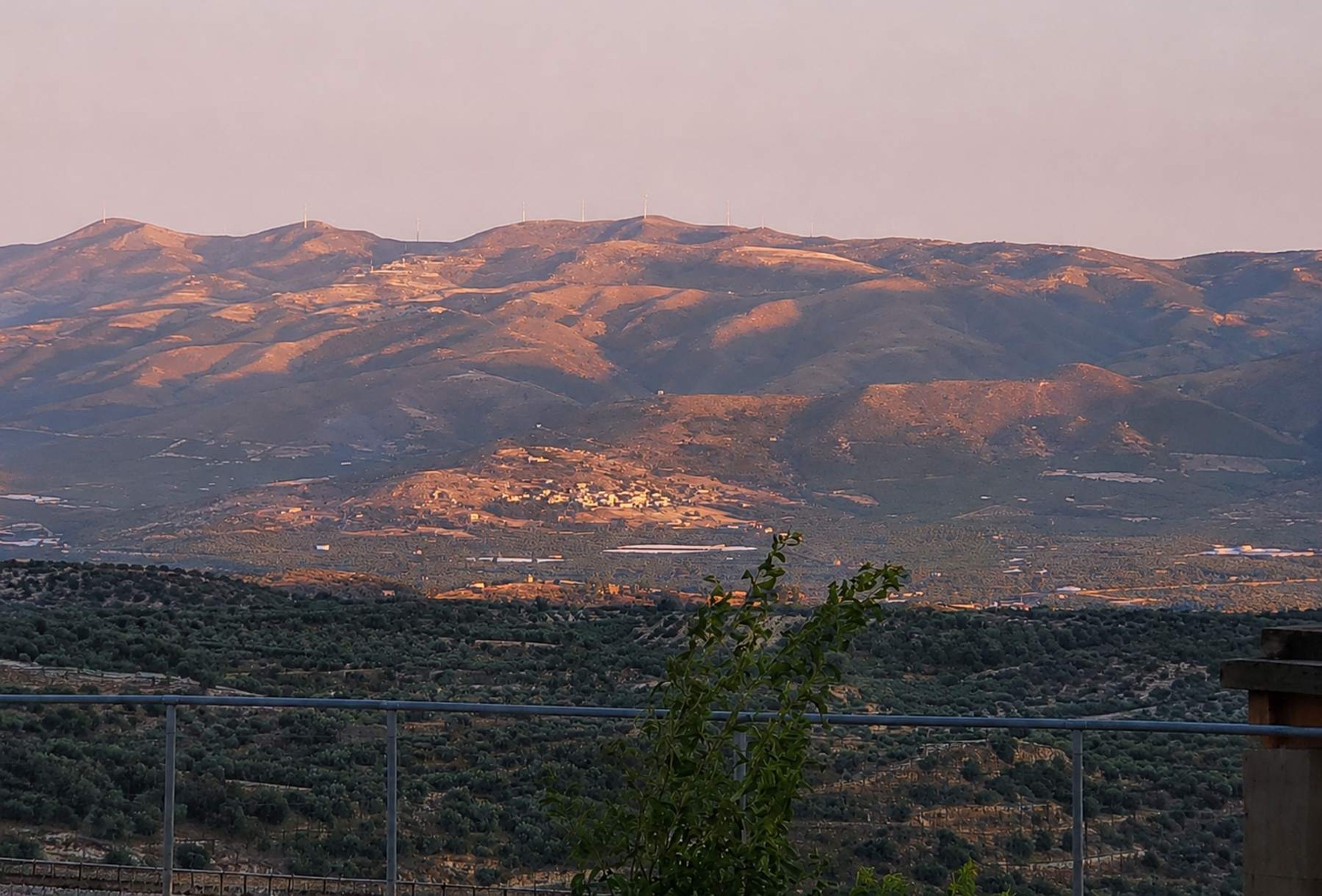 A mountainous landscape with a town in the valley below.