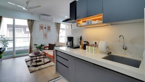 A modern kitchen with a central island, a built-in oven, and a sink.
