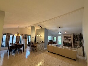 A spacious living area with a dining table, bar, and sofa. - 3-bedroom house in charming Houston with cool AC (Houston)