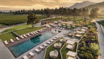 A resort with a swimming pool, lounge areas, and landscaped gardens.