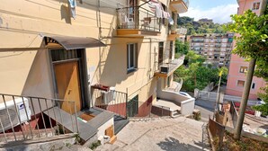 A residential building with balconies, a staircase, and a view of the surrounding neighborhood. - Standard Studio Apartment with Wi-Fi and Air Conditioning (Salerno)