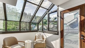 A room with a skylight, a wooden door, and two chairs. - Park City Gem w/ Hot Tub + Sauna: Walk to Main St (Park City)