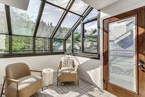 A room with a skylight, a wooden door, and two chairs. - Park City Gem w/ Hot Tub + Sauna: Walk to Main St (Park City)