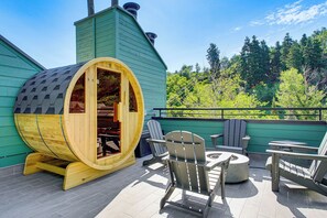 A wooden sauna with a curved roof, a seating area with Adirondack chairs, and a view of a forested area. - Park City Gem w/ Hot Tub + Sauna: Walk to Main St (Park City)