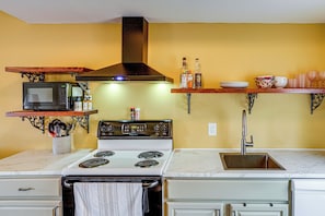 A kitchen with a stove, microwave, and a sink. - Peaceful Upstate Retreat! Walk to Hudson River (Coxsackie)