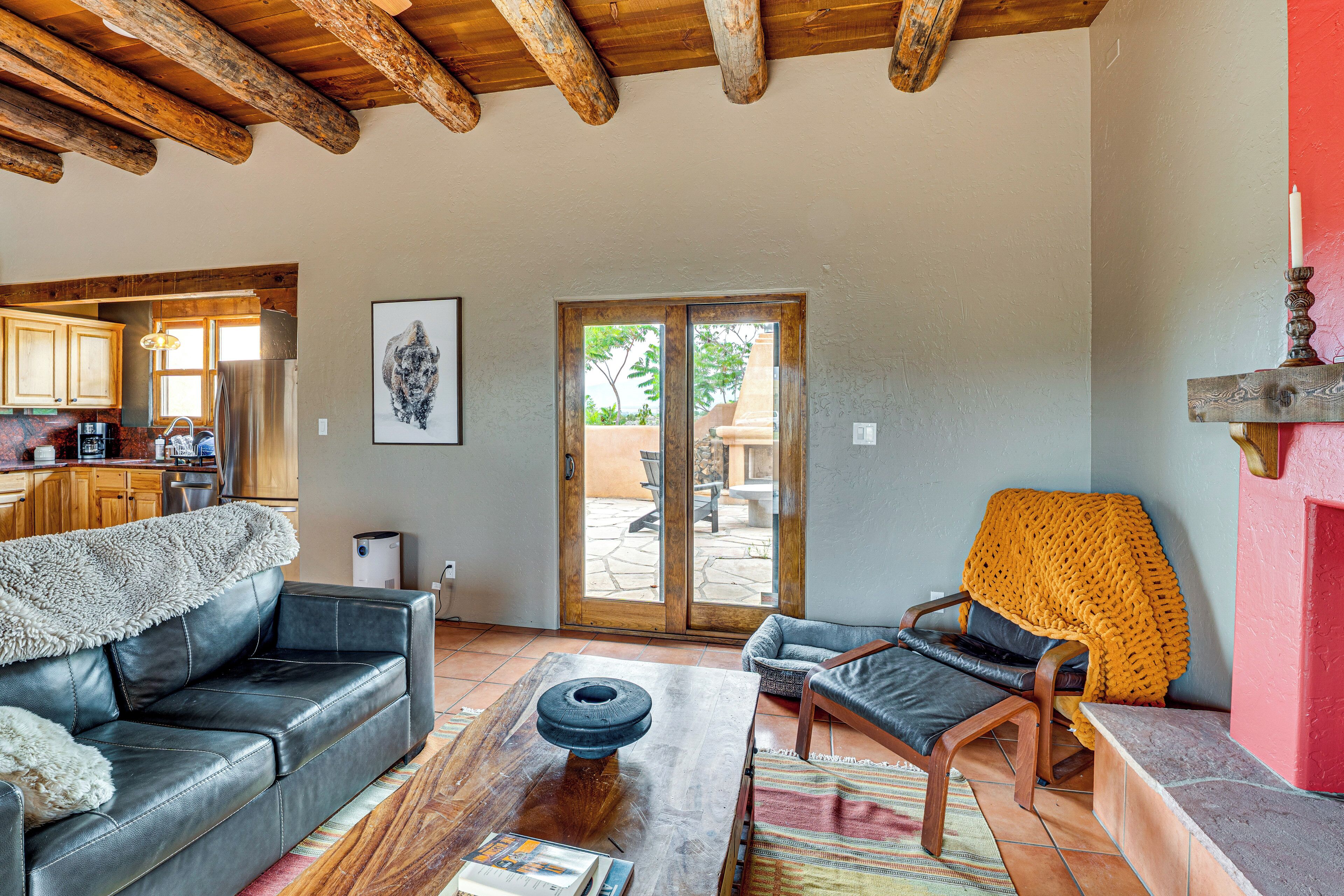 A living room with a sofa, armchair, coffee table, and a fireplace.