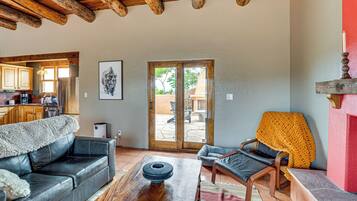 A living room with a sofa, armchair, coffee table, and a fireplace.