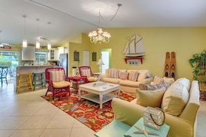 A spacious living area with a sofa, chairs, a coffee table, and a kitchen in the background. - 4 Mi to Siesta Key Beach! Spacious Family Getaway (Sarasota)