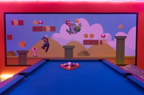A pool table with a Mario-themed mural in the background. - Golf Course Retreat w/ Pool, Spa & Game Room, Disney (Davenport)