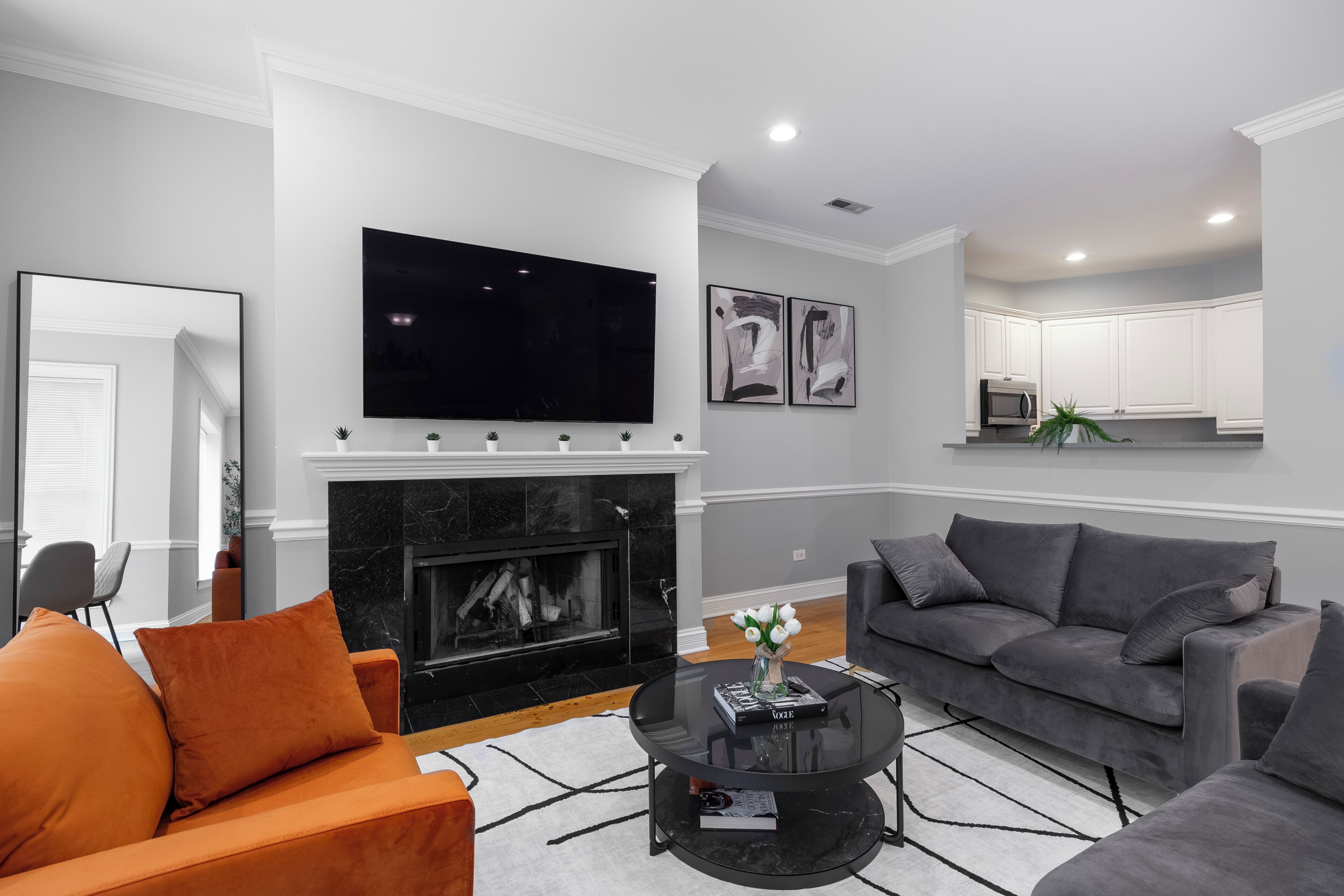 A living room with a fireplace, a flat-screen TV, a sofa, and a coffee table.