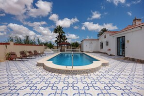 A swimming pool with lounge chairs, a gazebo, and a tiled patio. - Villa Mariposa Azul with a private pool, terrace, and views of the Salt Lake (Torrevieja)