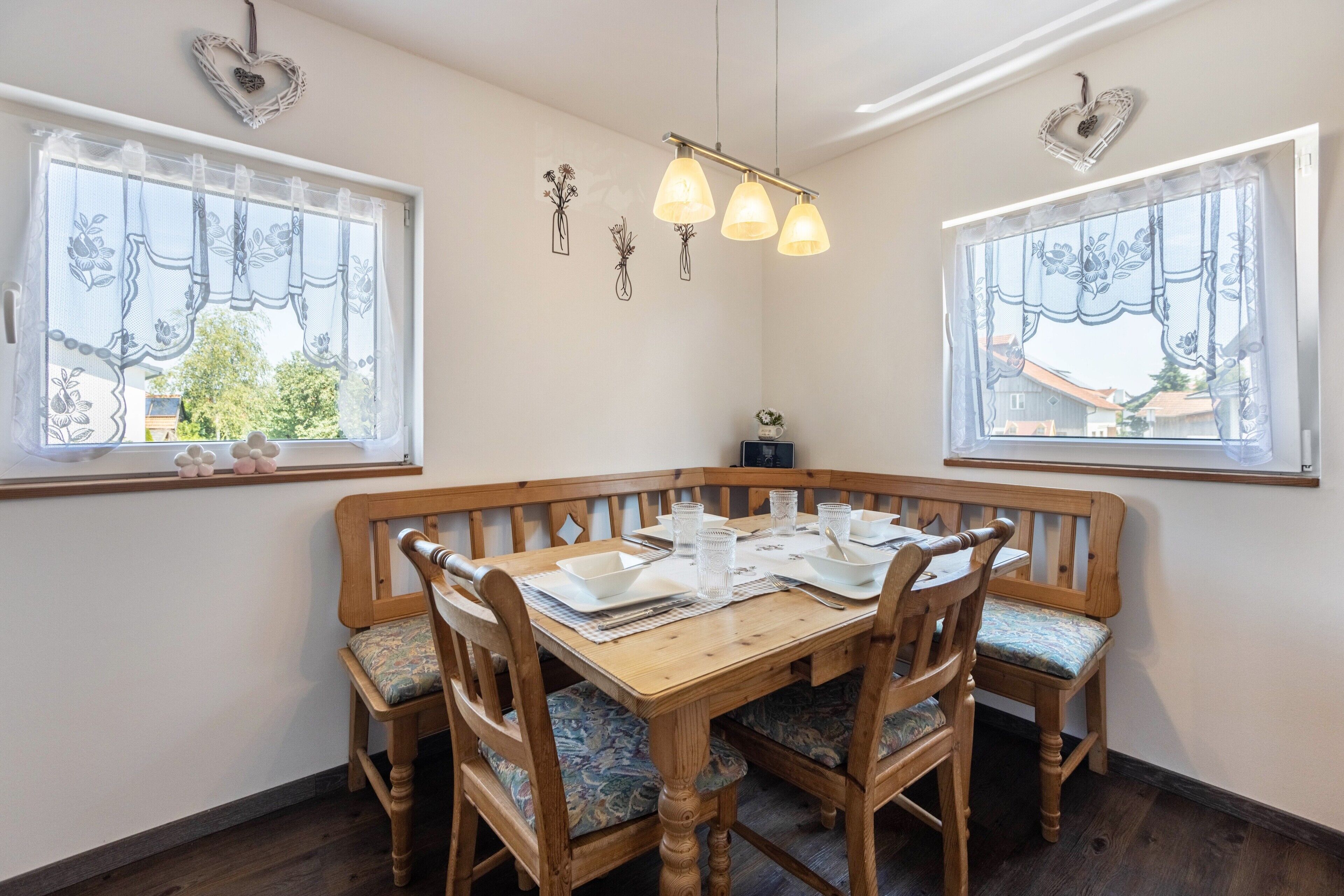 A dining area with a wooden table, chairs, and a bench.