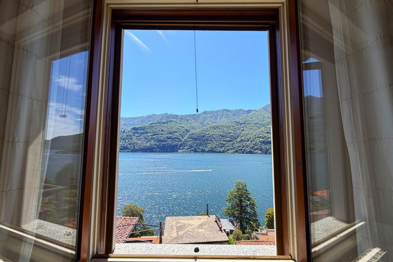 A window with a view of a lake and mountains.
