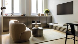 A modern kitchen with a large window, a flat-screen TV, and a minimalist design. - Luxurious Suite - AC- 2P- Madeleine/saint Honore (Paris)