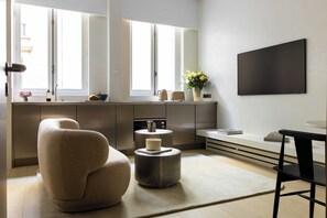 A modern kitchen with a large window, a flat-screen TV, and a minimalist design. - Luxurious Suite - AC- 2P- Madeleine/saint Honore (Paris)