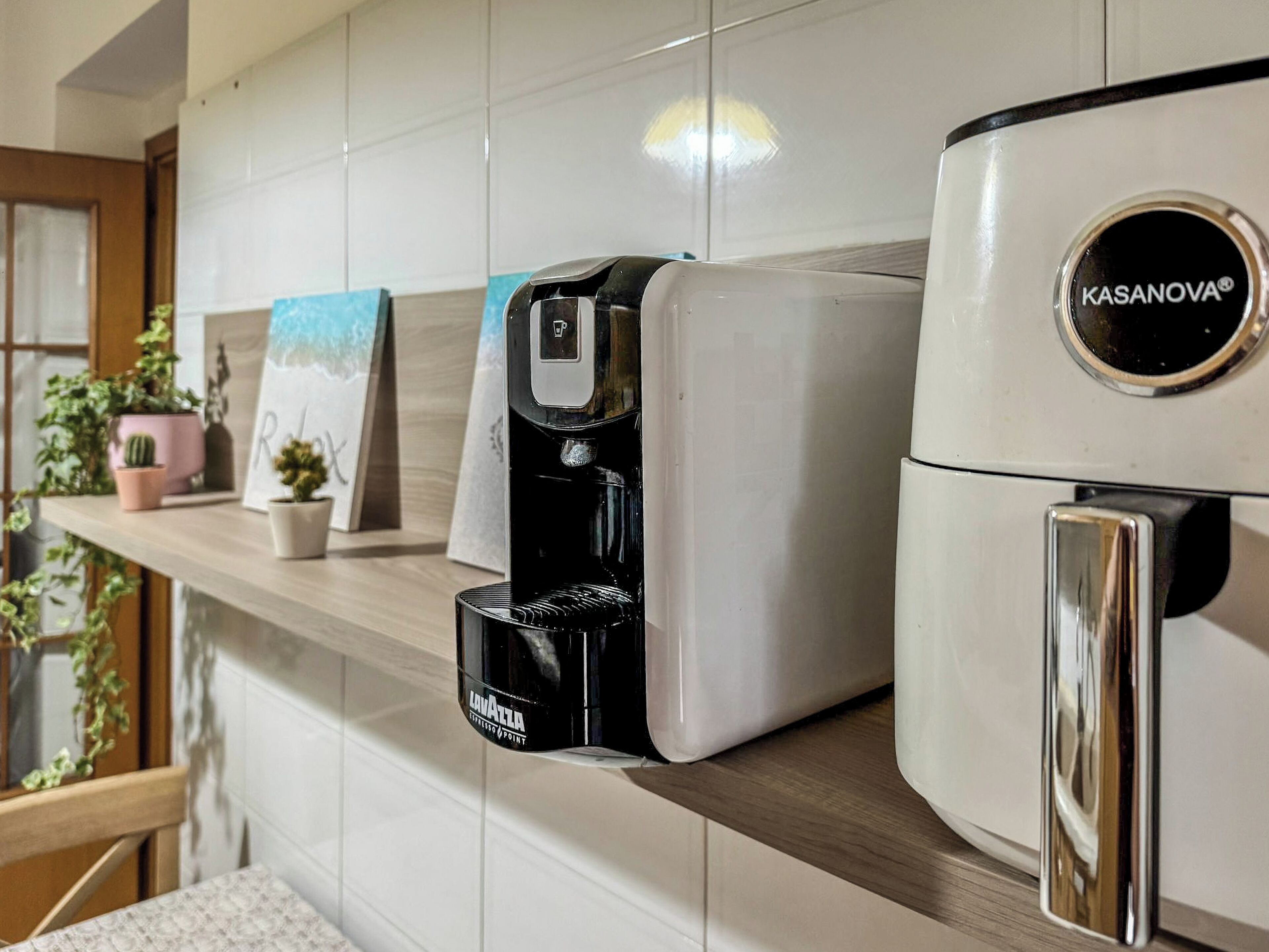 A coffee maker and a water dispenser on a kitchen counter.