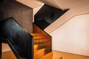 A modern staircase with wooden steps and black railings. - DS Destination Specialist Hotel (Guilin)