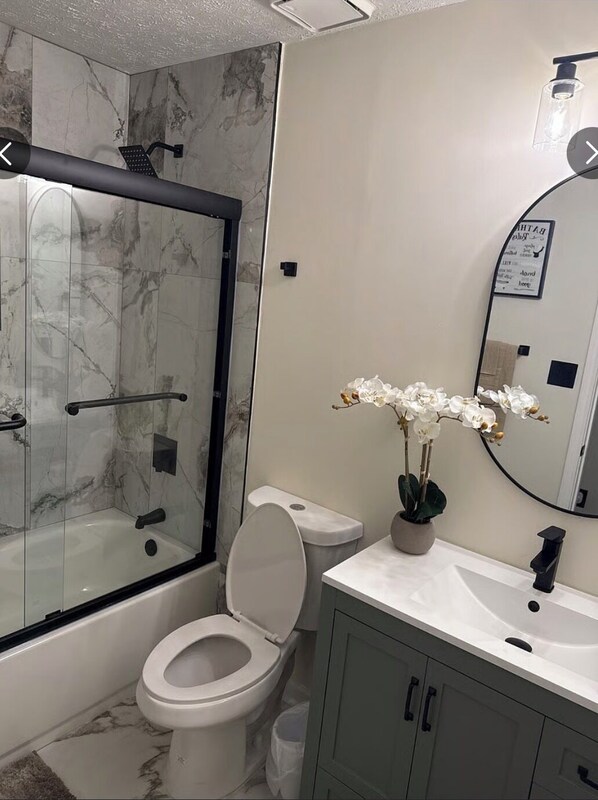 Shower, hair dryer, towels, toilet paper