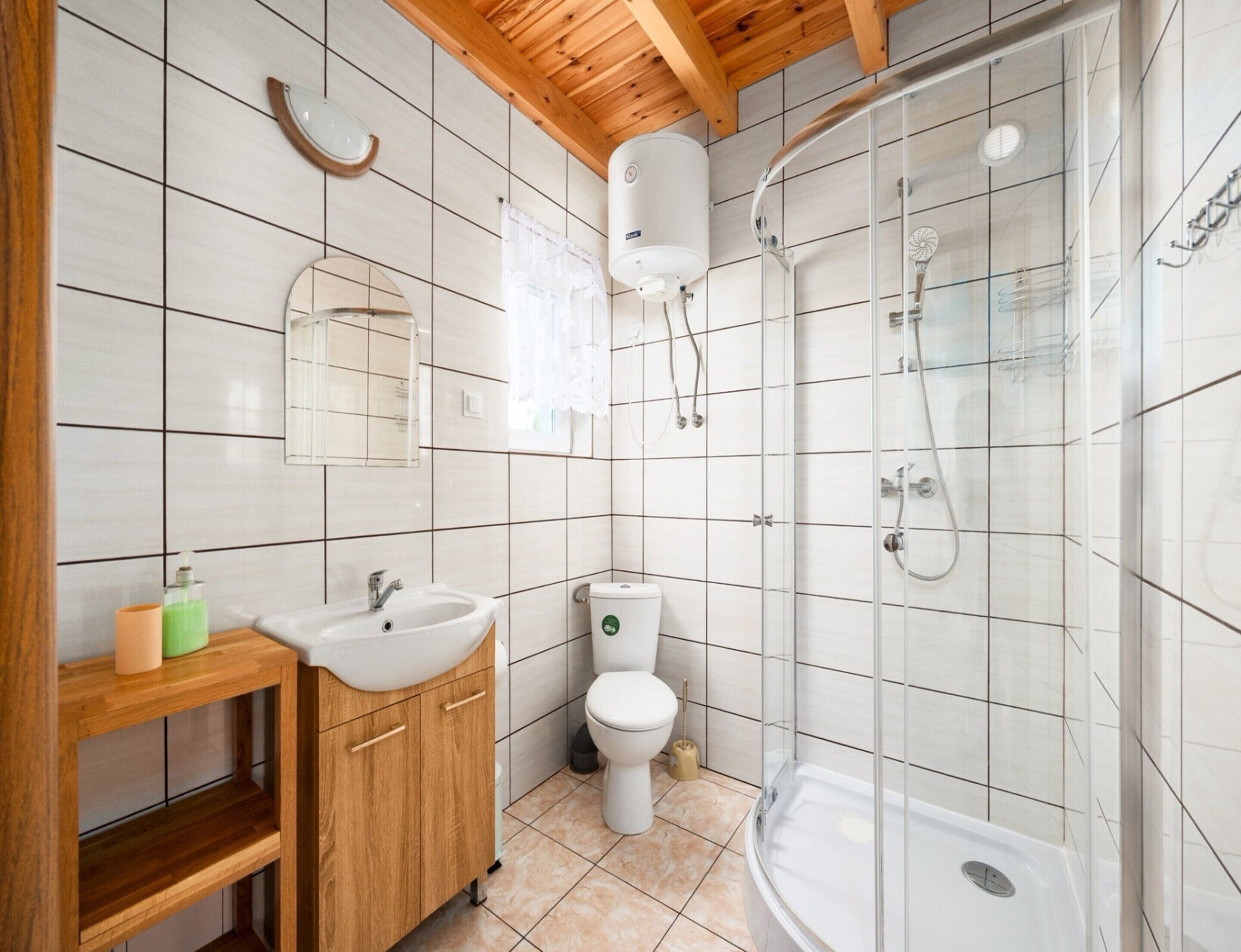 A bathroom with a sink, toilet, shower, and bathtub.