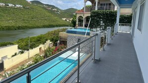 A hotel with a pool, a view of a river, and a mountainous landscape. - Belair Pool Villa w/ Rooftop & Island Views Oasis (Little Bay)