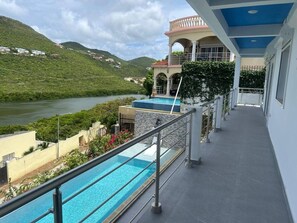 A hotel with a pool, a view of a river, and a mountainous landscape. - Belair Pool Villa w/ Rooftop & Island Views Oasis (Little Bay)