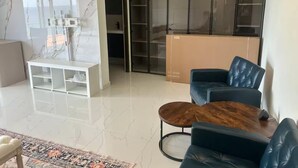 A modern living room with a sofa, coffee table, and a patterned rug. - Belair Pool Villa w/ Rooftop & Island Views Oasis (Little Bay)