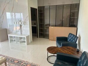 A modern living room with a sofa, coffee table, and a patterned rug. - Belair Pool Villa w/ Rooftop & Island Views Oasis (Little Bay)