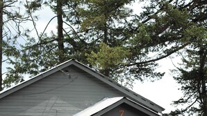 A small, single-story cabin with a porch, a visible door, and a number '7' on the front.