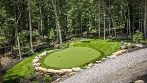 Golfkenttä, jonka ympärillä on puita.