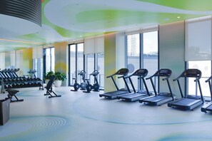 A gym with treadmills, dumbbells, and exercise equipment. - Luxury 3BR - Rooftop Pool - One Free Parking Spot (Miami)