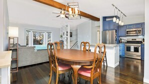 A modern kitchen with blue cabinets, a stainless steel refrigerator, and a built-in oven. - Family-Friendly 4-Bed Retreat. Entire home in Eagan, Minnesota, United States (Eagan)