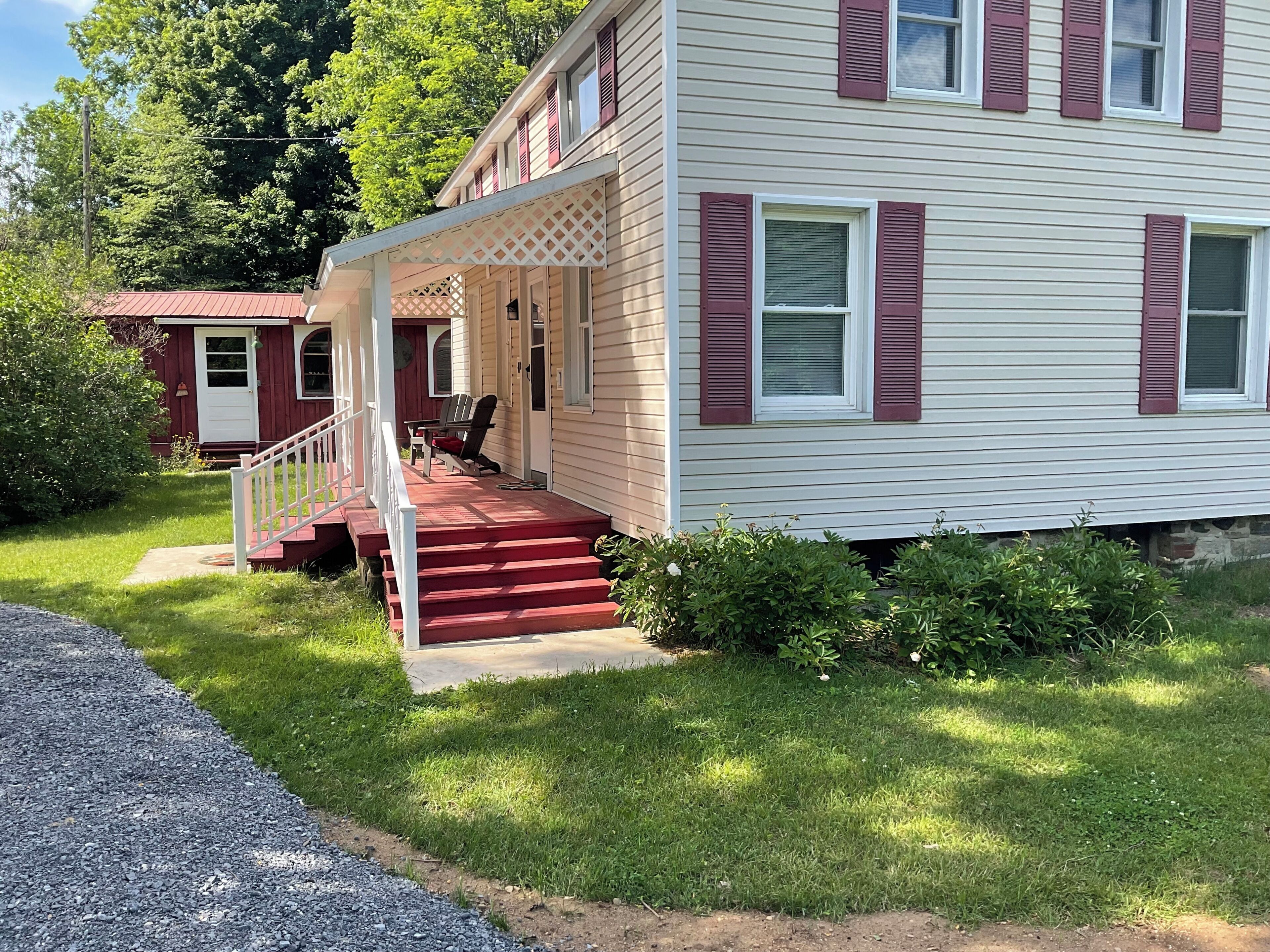 A two-story house with a porch and a small attached garage.