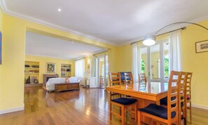 A dining area with a wooden table and chairs, a sofa, and a fireplace. - Polo Turistico Umbria Villa Fulginia (Foligno)