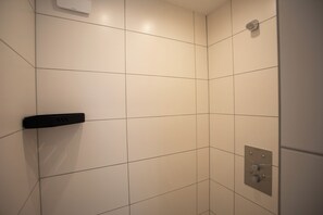 A tiled shower area with a control panel and a handheld showerhead. - Walters Weidelbach House in Haiger, Lahn-Dill District (Haiger)