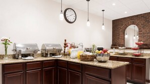 A kitchen with a brick wall, a clock, and various food items on the counter. - Albany Cozy Room W/Breakfast Next to Downtown (Albany)