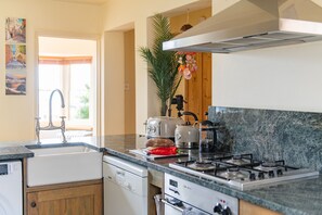 A kitchen with a sink, stove, and countertop. - The Cottage, Whitstable (Whitstable)